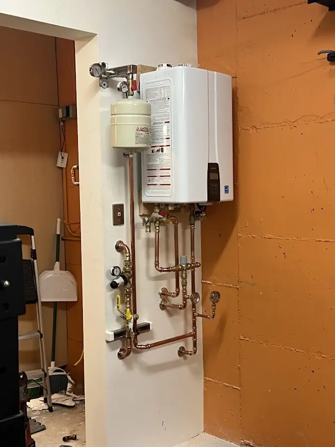 Plumbing technician inspecting water heater connections in Hollywood Park
